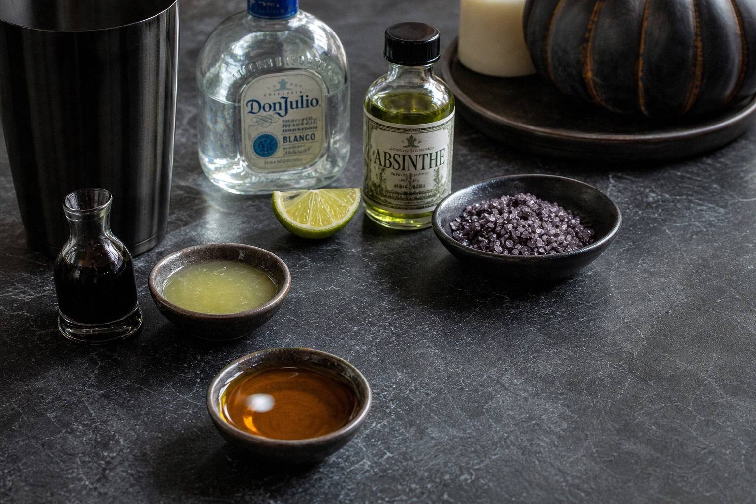 ingredients for black halloween margarita including tequila, absinthe, lime juice, agave nectar, activated charcoal, and purple salt