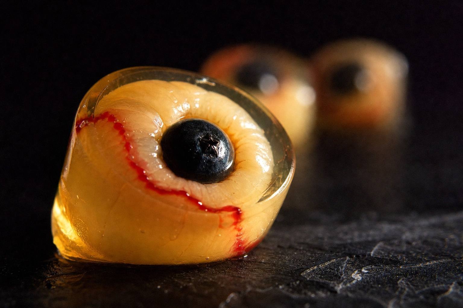 A close view of one lychee eyeball shot with a blueberry pupil