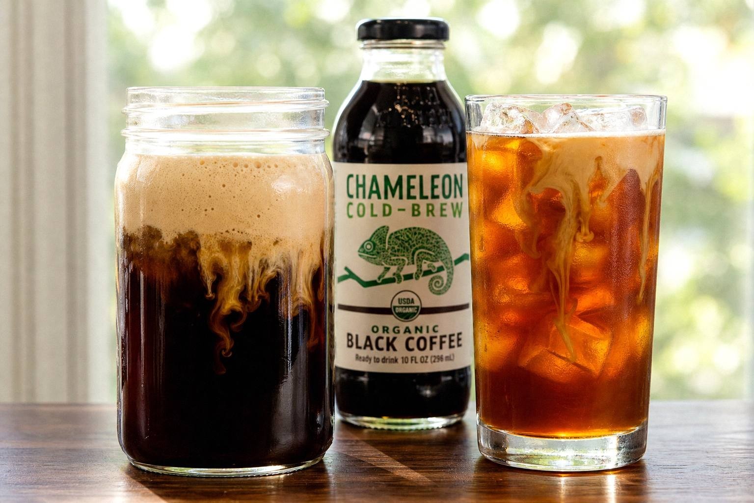 Jar of cold brew coffee beside a glass of iced coffee showing the difference in color and body