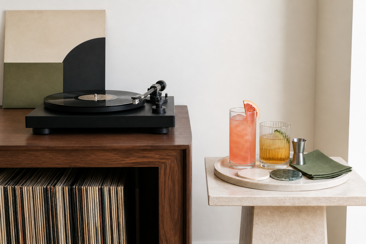 Close view of a level turntable on a dry walnut console with records stored upright below and a separate drink tray on a side table